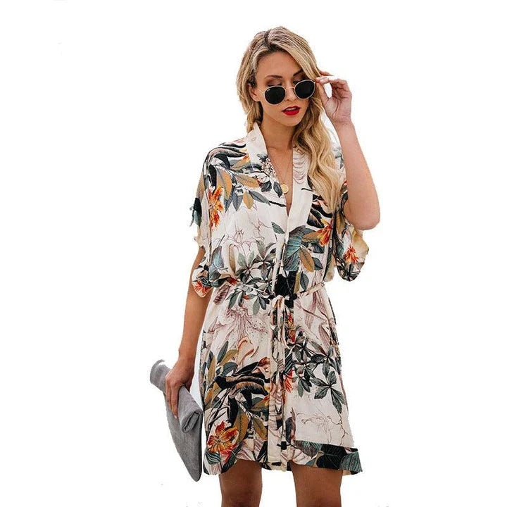Stylish printed v-neck dress in apricot color, featuring a flattering silhouette and premium materials for a timeless, elegant look.