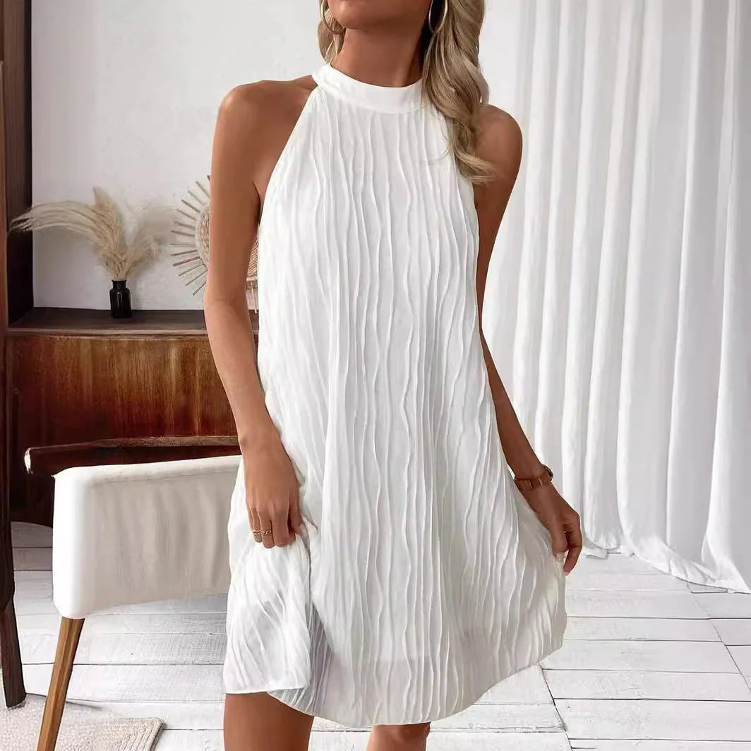 Elegant white backless halter dress with a flattering silhouette and mid-length hemline