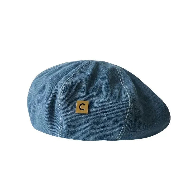 A stylish Japanese-inspired denim beret with a dome-shaped crown and a brimless silhouette, available in light, medium, and dark denim shades.