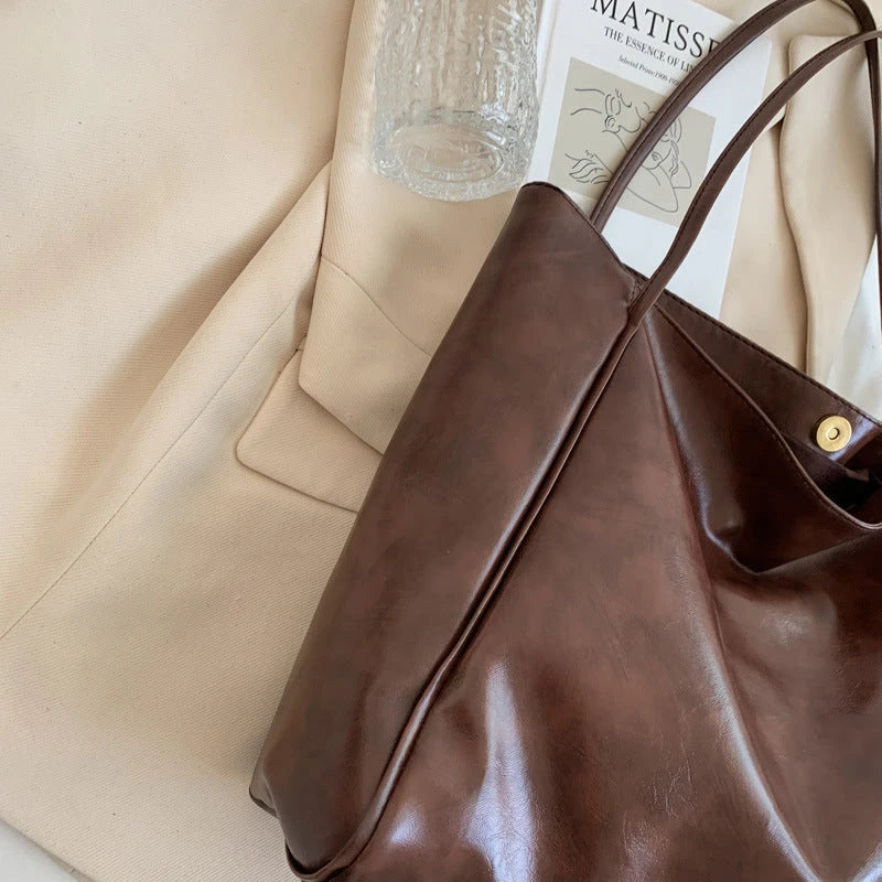 Premium faux leather shoulder bag in various colors, featuring a classic silhouette and roomy interior for everyday convenience.
