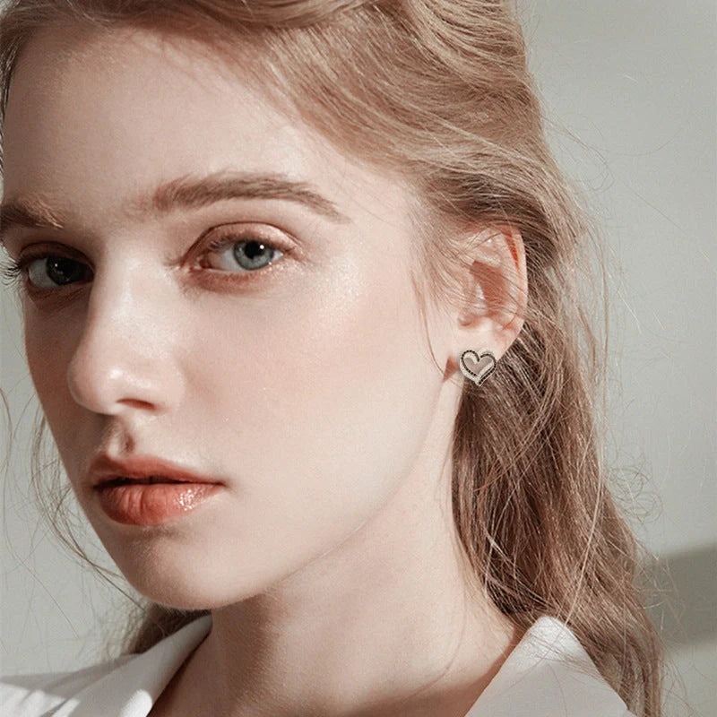 Stylish copper heart-shaped earrings with a double buckle design, perfect for adding a touch of elegance to any outfit.