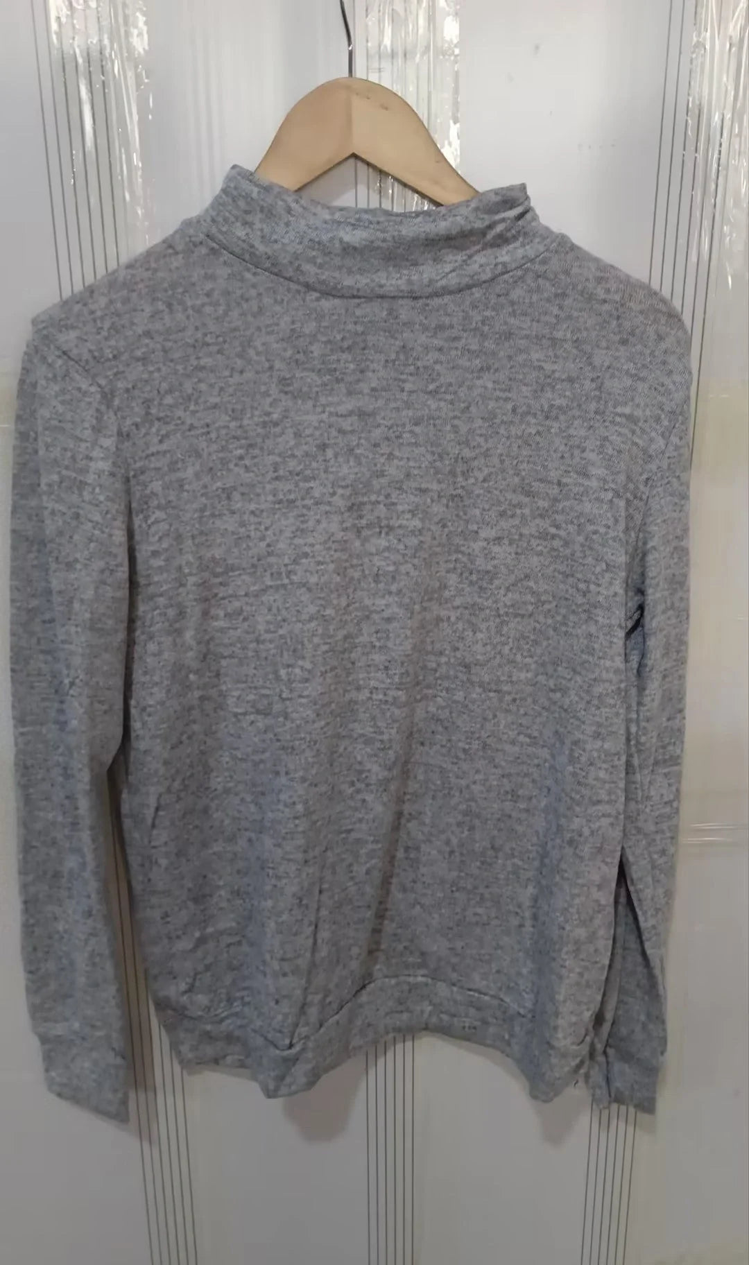 A long sleeve knitted jumper in various solid colours, including light gray, black, khaki, blue, and pink