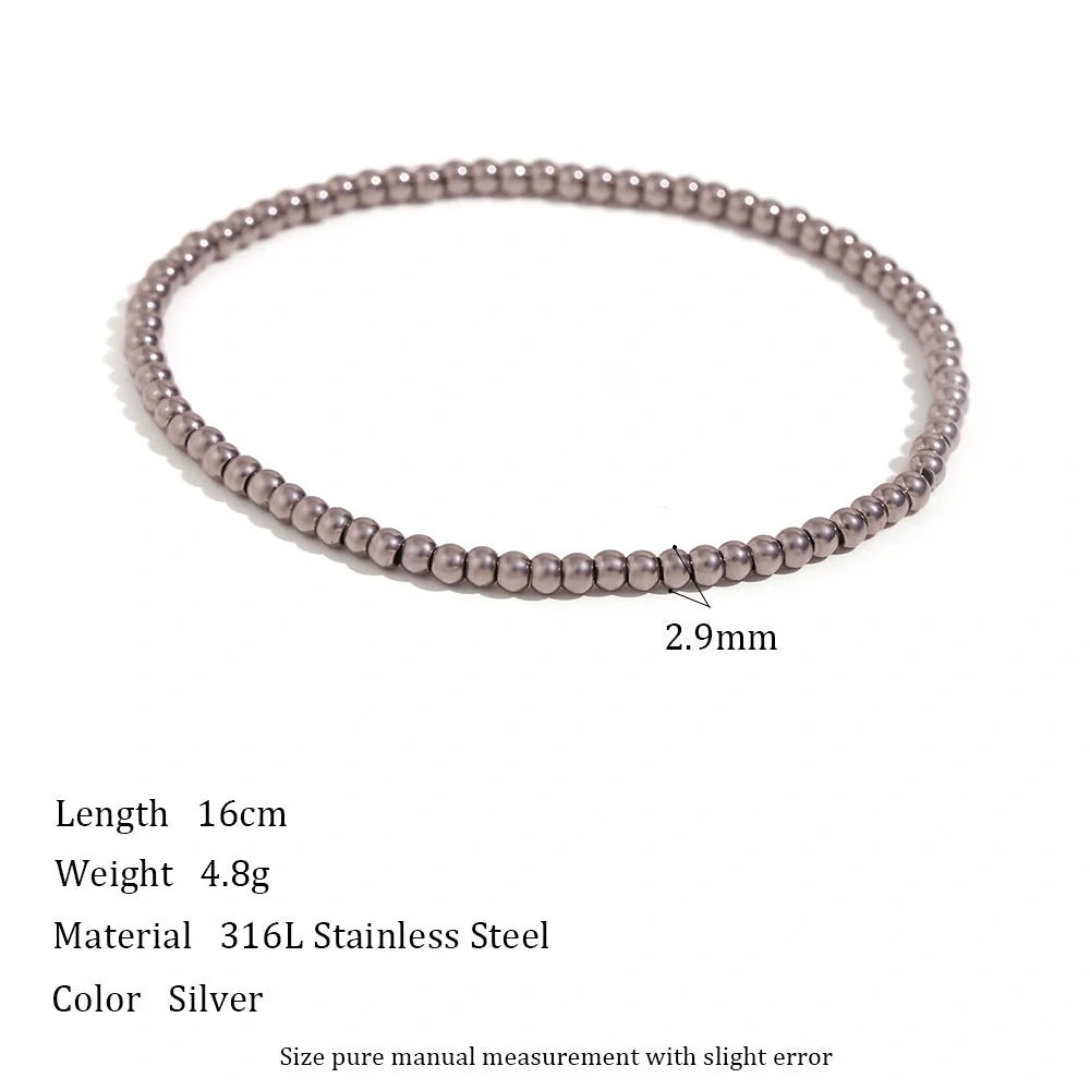 Vintage-inspired stainless steel and 18K plated elastic bead bracelet in a range of sizes and colours