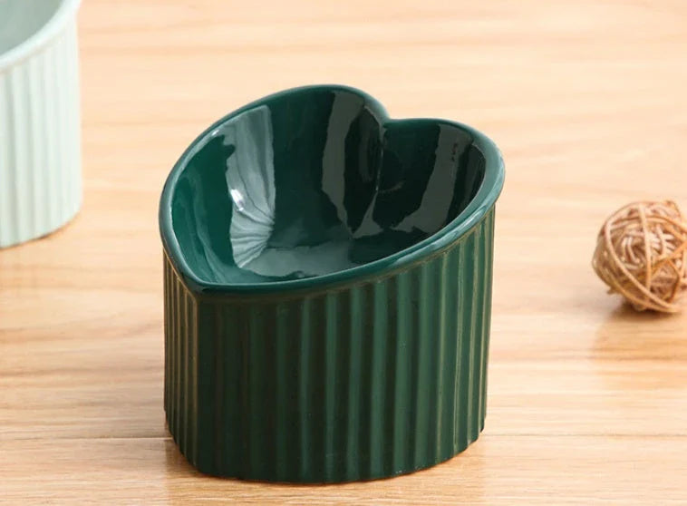 Elevated ceramic pet bowl with angled design for comfortable, natural feeding of cats and dogs