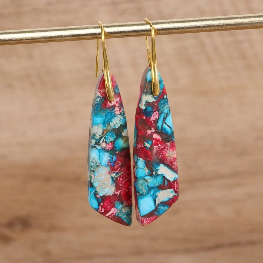 Geometric flower shape pendant earrings in copper with gold hooks, available in red, green, and blue.
