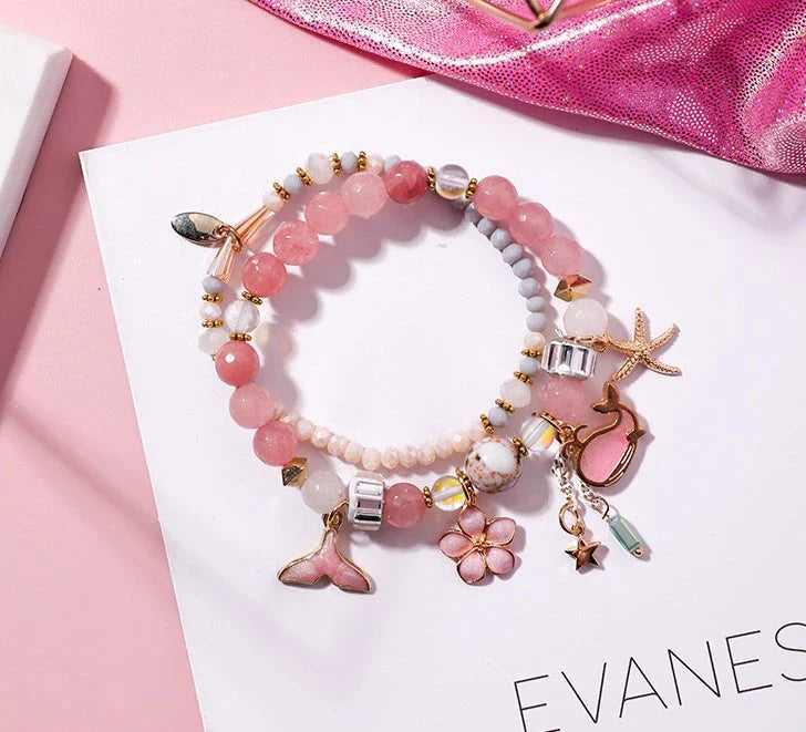 Elegant whale tail bracelet with floral charm in a variety of vibrant colours