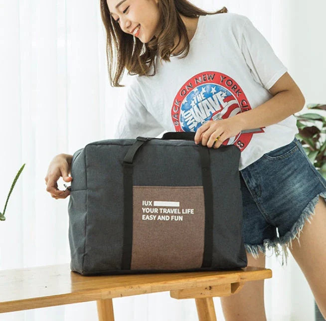 Foldable nylon travel holdall in various colours, including black, orange, green, and red