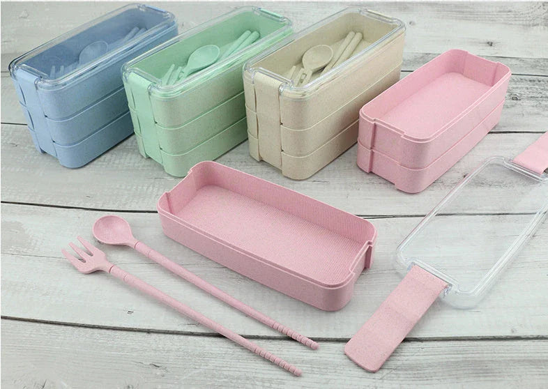 A stylish microwave-safe lunch box with a removable soup mug in various colours, including pink, green, and apricot