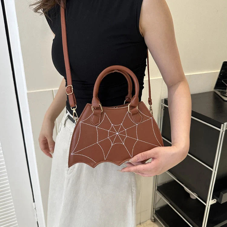 Trendy spider web-patterned shoulder bags in various colours, perfect for adding a spooky-chic touch to your Halloween outfit