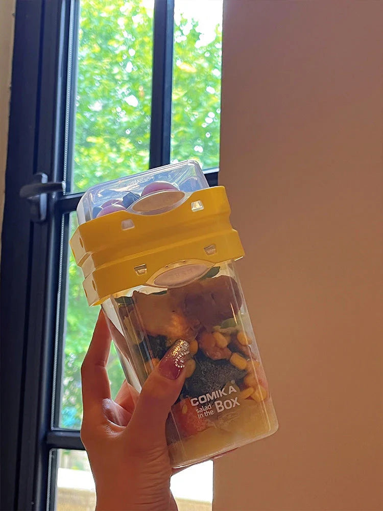 Dual-layer meal prep container with separate compartments and leak-proof lid, available in yellow and cream white colors
