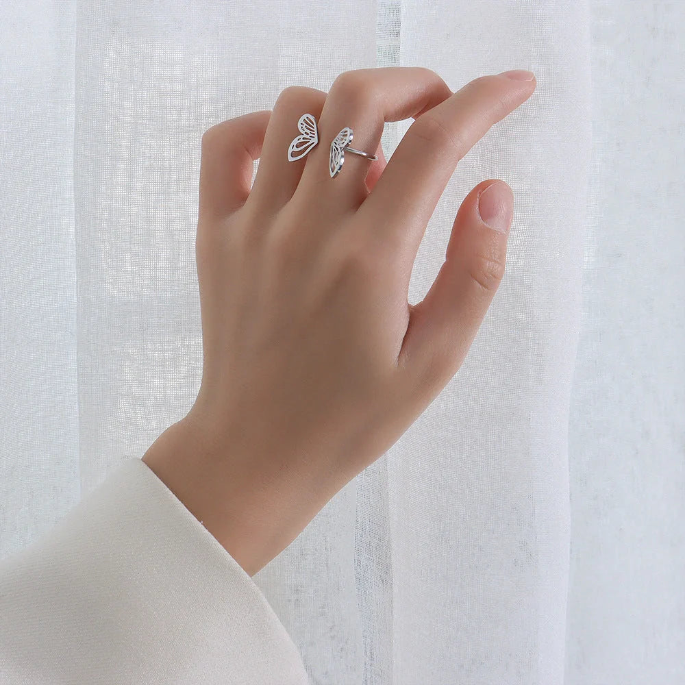 Adjustable hollow butterfly ring in titanium steel, available in golden and steel colours.