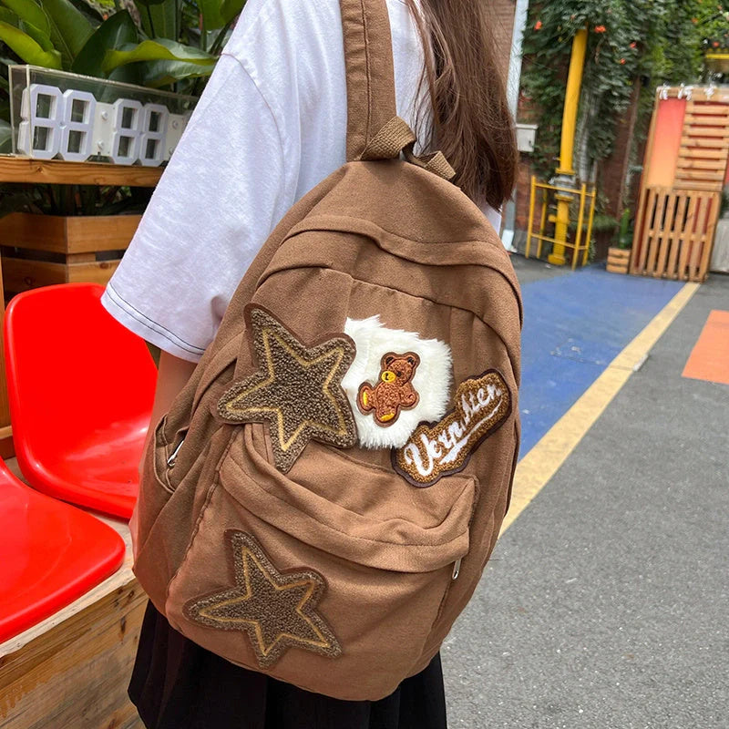 A stylish and durable canvas backpack with geometric patterns, designed for female college students