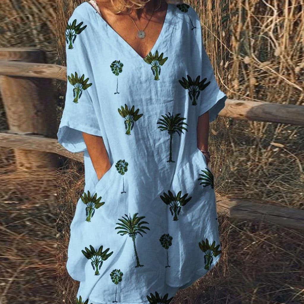 Trendha Leaf Print V-Neck Casual Flared Dress in blue with a vibrant leaf pattern, v-neck, and flared skirt design