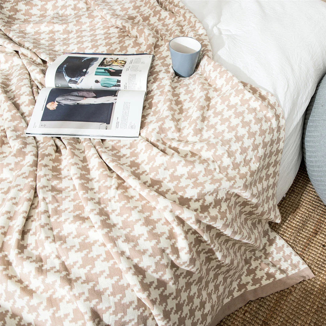 A cosy and stylish houndstooth plaid cotton blanket in various colour combinations, perfect for adding comfort and elegance to any living space.