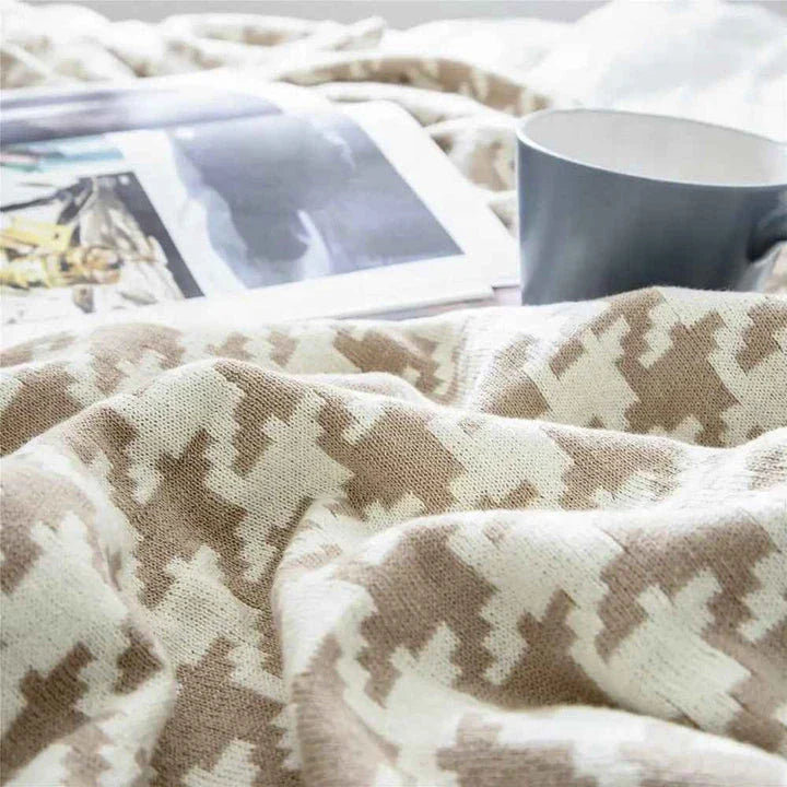 A cosy and stylish houndstooth plaid cotton blanket in various colour combinations, perfect for adding comfort and elegance to any living space.