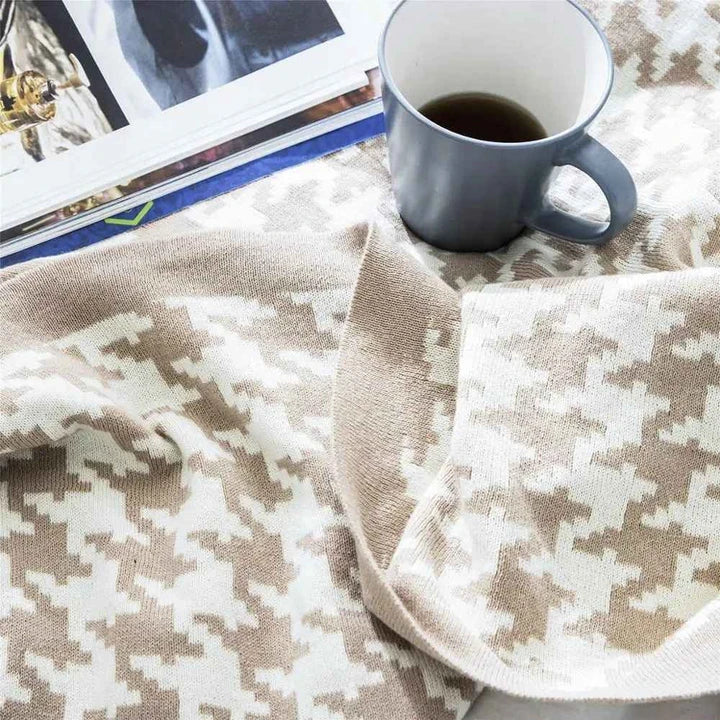 A cosy and stylish houndstooth plaid cotton blanket in various colour combinations, perfect for adding comfort and elegance to any living space.