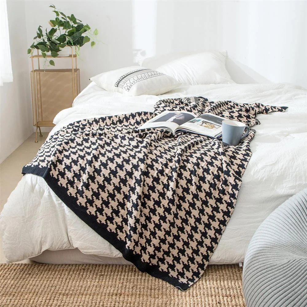 A cosy and stylish houndstooth plaid cotton blanket in various colour combinations, perfect for adding comfort and elegance to any living space.
