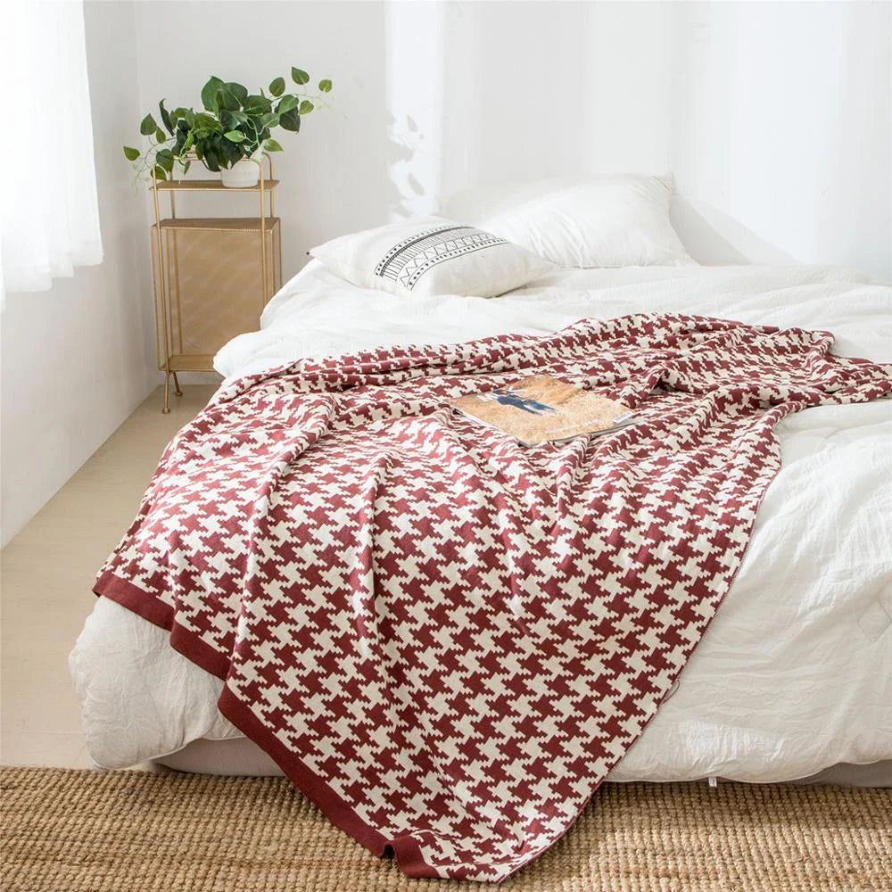 A cosy and stylish houndstooth plaid cotton blanket in various colour combinations, perfect for adding comfort and elegance to any living space.