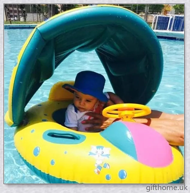 A baby swimming in a blue and white clamshell-style inflatable swimming pool float with a sun canopy and steering wheel