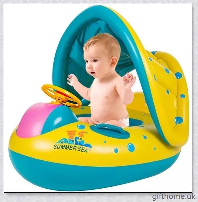 A baby swimming in a blue and white clamshell-style inflatable swimming pool float with a sun canopy and steering wheel