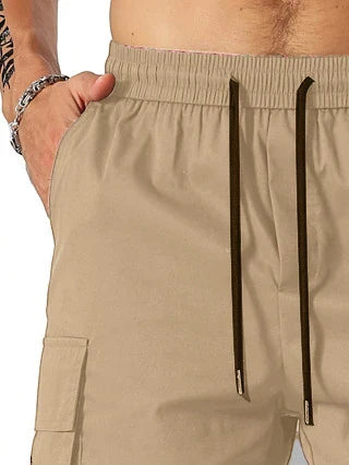 Drawstring waist men's multi-pocket workwear shorts in various colours, designed for comfort and functionality on the job site or for DIY projects.