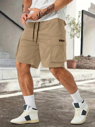 Drawstring waist men's multi-pocket workwear shorts in various colours, designed for comfort and functionality on the job site or for DIY projects.