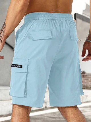 Drawstring waist men's multi-pocket workwear shorts in various colours, designed for comfort and functionality on the job site or for DIY projects.