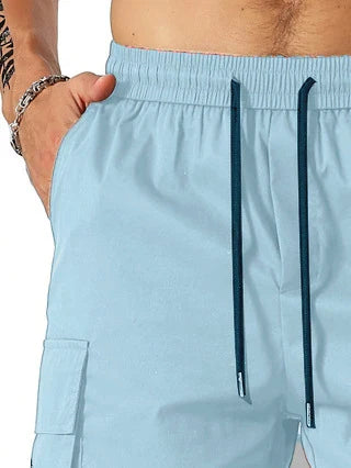 Drawstring waist men's multi-pocket workwear shorts in various colours, designed for comfort and functionality on the job site or for DIY projects.