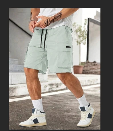 Drawstring waist men's multi-pocket workwear shorts in various colours, designed for comfort and functionality on the job site or for DIY projects.