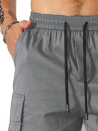 Drawstring waist men's multi-pocket workwear shorts in various colours, designed for comfort and functionality on the job site or for DIY projects.
