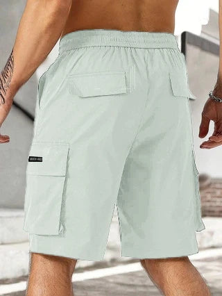 Drawstring waist men's multi-pocket workwear shorts in various colours, designed for comfort and functionality on the job site or for DIY projects.