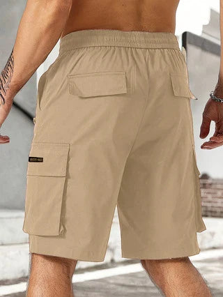 Drawstring waist men's multi-pocket workwear shorts in various colours, designed for comfort and functionality on the job site or for DIY projects.