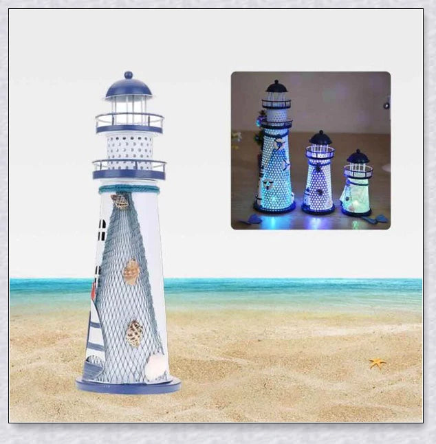 Oceanica LED Lighthouse Lantern Nightlight with nautical details like a small boat, life buoy, and seashells, providing a soft warm glow.