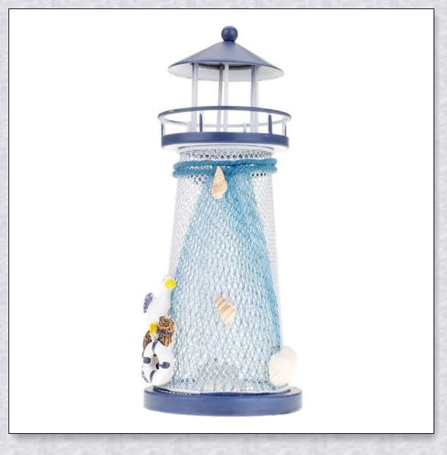 Oceanica LED Lighthouse Lantern Nightlight with nautical details like a small boat, life buoy, and seashells, providing a soft warm glow.