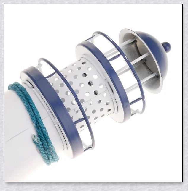 Oceanica LED Lighthouse Lantern Nightlight with nautical details like a small boat, life buoy, and seashells, providing a soft warm glow.