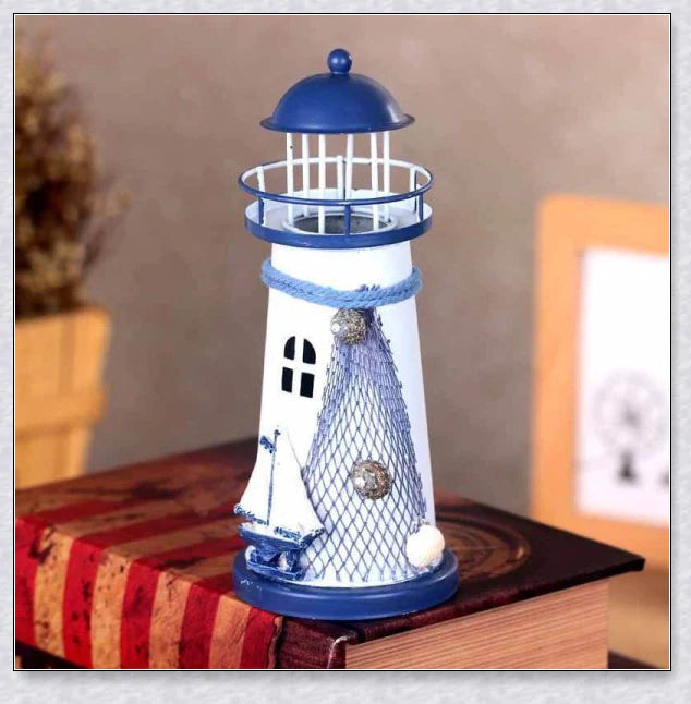 Oceanica LED Lighthouse Lantern Nightlight with nautical details like a small boat, life buoy, and seashells, providing a soft warm glow.