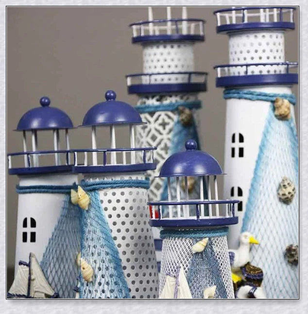Oceanica LED Lighthouse Lantern Nightlight with nautical details like a small boat, life buoy, and seashells, providing a soft warm glow.