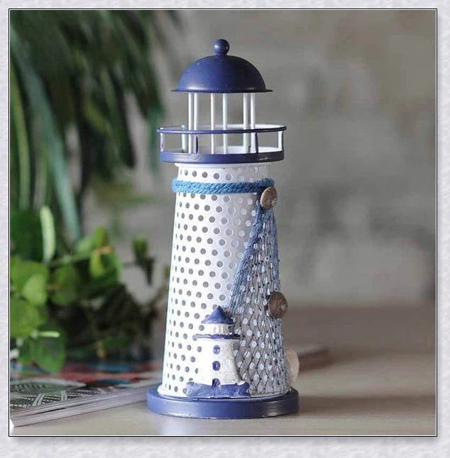 Oceanica LED Lighthouse Lantern Nightlight with nautical details like a small boat, life buoy, and seashells, providing a soft warm glow.