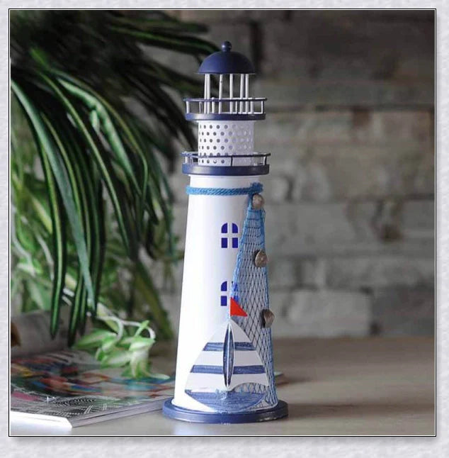 Oceanica LED Lighthouse Lantern Nightlight with nautical details like a small boat, life buoy, and seashells, providing a soft warm glow.