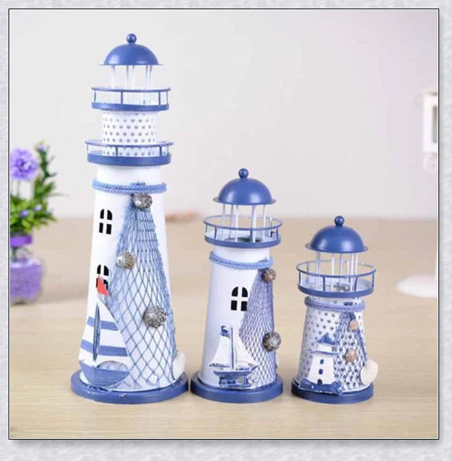 Oceanica LED Lighthouse Lantern Nightlight with nautical details like a small boat, life buoy, and seashells, providing a soft warm glow.