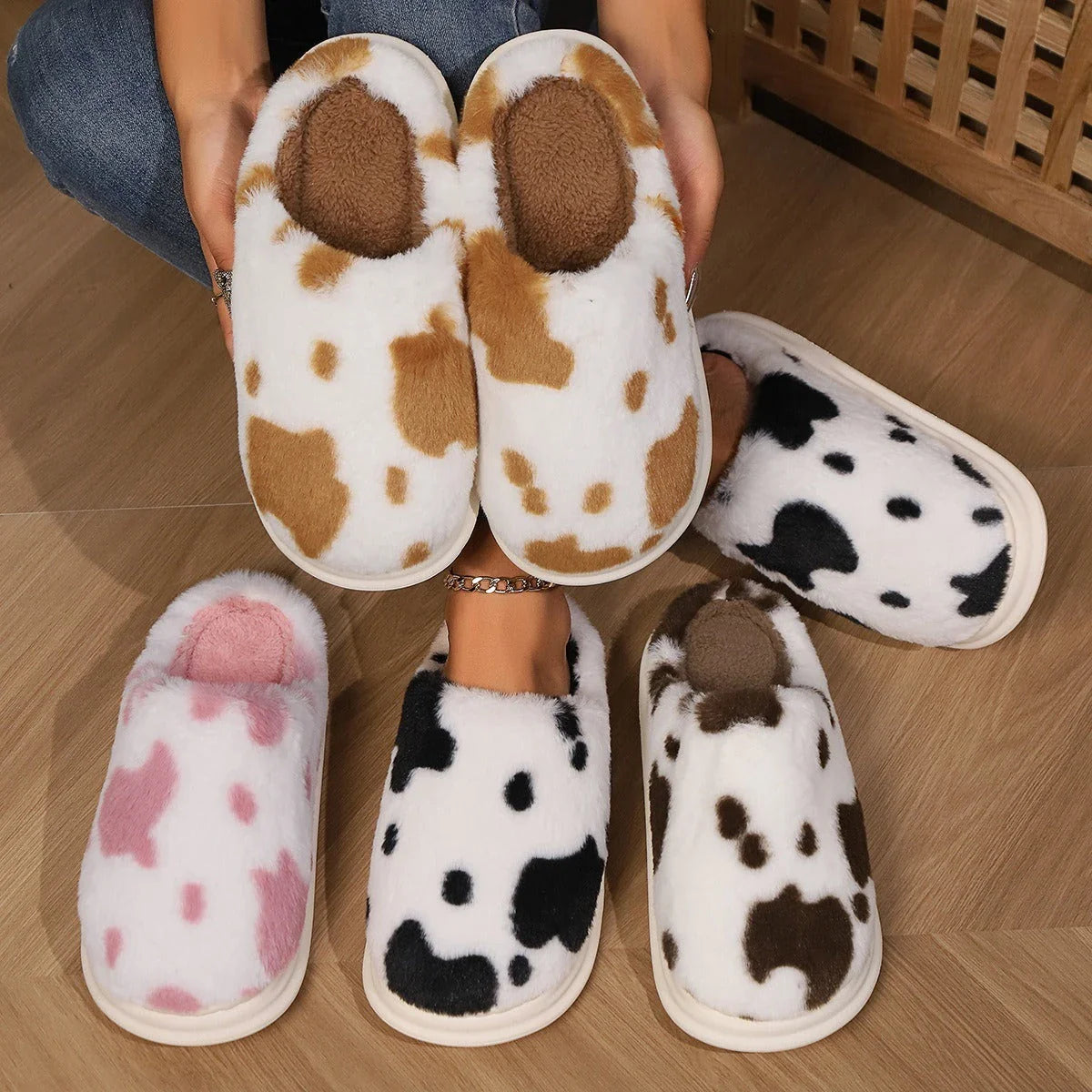 Cozy cow print plush slippers with a non-slip sole, perfect for indoor comfort and warmth
