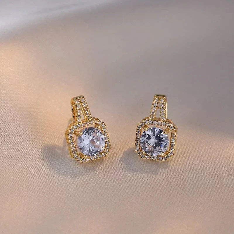Elegant gold-toned jewelry set with zircon gemstone pendant necklace, stud earrings, and statement ring