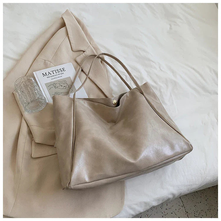 Premium faux leather shoulder bag in various colors, featuring a classic silhouette and roomy interior for everyday convenience.