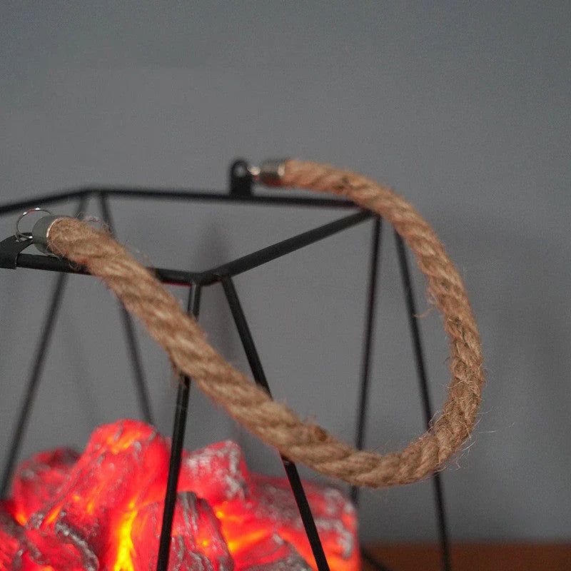 A charcoal-coloured fireplace lamp with a mesmerising LED flame effect, creating a cosy and inviting atmosphere in a living room.