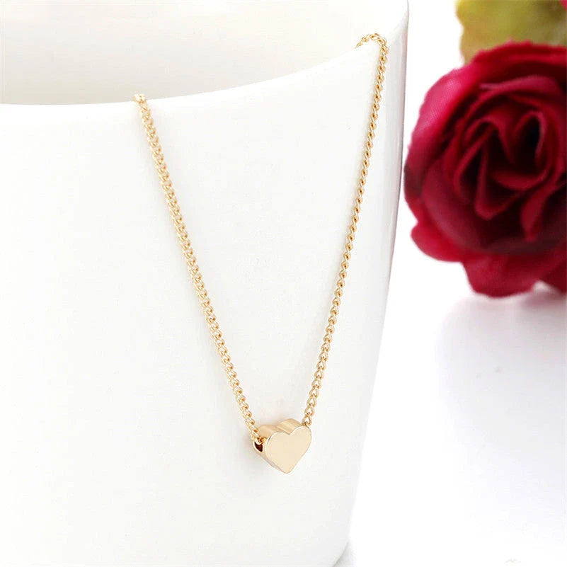 Elegant gold-tone double-sided love pendant necklace with a sleek clavicle chain design
