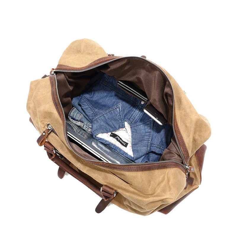A large, khaki-coloured canvas crossbody luggage bag with multiple pockets and compartments for organised travel