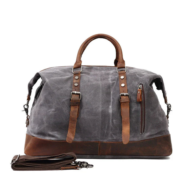 A large, khaki-coloured canvas crossbody luggage bag with multiple pockets and compartments for organised travel