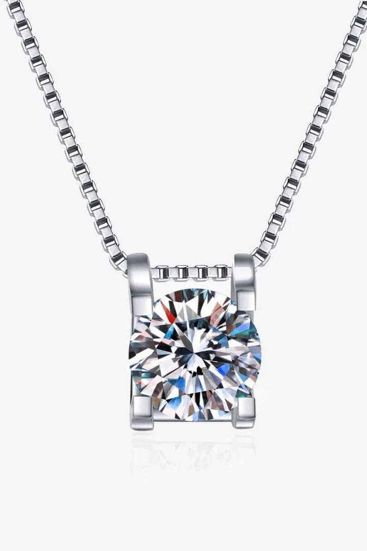 Closeup view of a sparkling 1 carat moissanite gemstone set in a rhodium-plated 925 sterling silver chain necklace