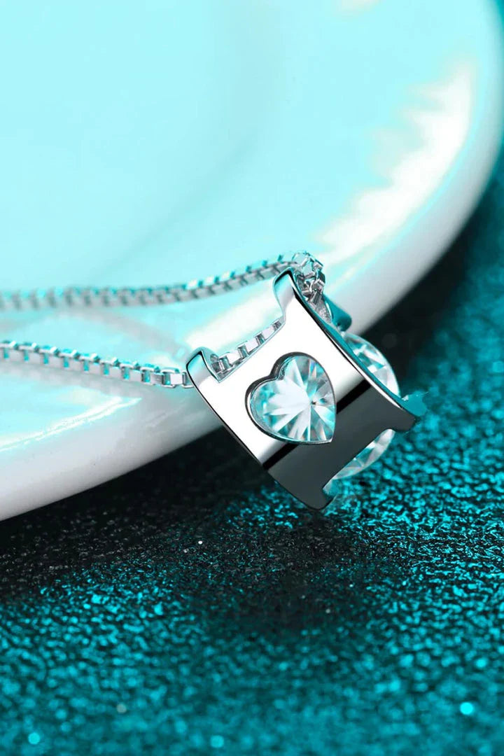 Closeup view of a sparkling 1 carat moissanite gemstone set in a rhodium-plated 925 sterling silver chain necklace