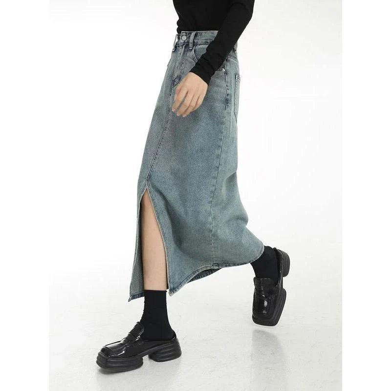 Chic vintage blue denim midi skirt with front slit, featuring a flattering A-line silhouette and stylish distressed details